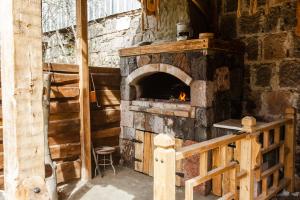a brick oven with a fire inside of it at ARmoon Hotel in Gyumri