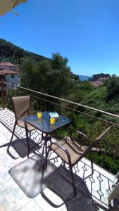 a table and chairs on a balcony with a view at DANDOLOS STUDIOS in Parga