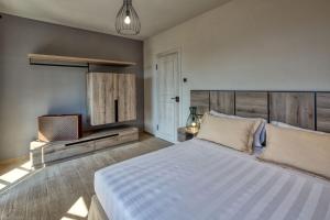 a bedroom with a large bed and a television at Mirandola Suites in Arenzano