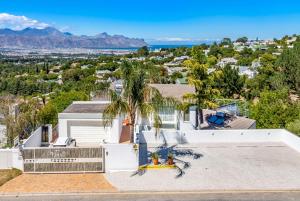 an aerial view of a house with a palm tree at Morgen Guesthouse Somerset West in Somerset West