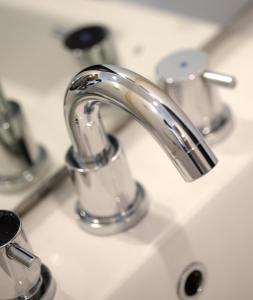 a bathroom sink with a silver faucet at Amaris Hotel Dr. Susilo Grogol in Jakarta