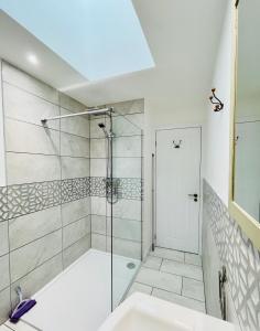 a bathroom with a glass shower and a sink at Tigh na Mara in Portsoy