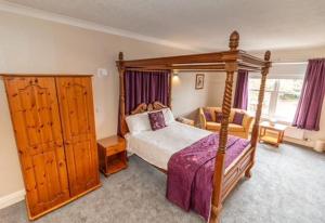 A bed or beds in a room at The Quorn Lodge Hotel