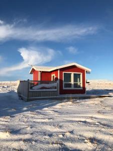 a small red house in the middle of the desert at Blue View Cabin 1B With private hot tub in Reykholt