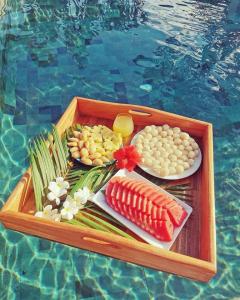 a tray of food on a table next to a pool at Alanta Private Pool Villa in Ko Lanta +32 photos