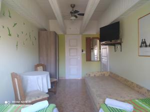 a room with a table and a dining room at Apartmanház Gabriella in Harkány