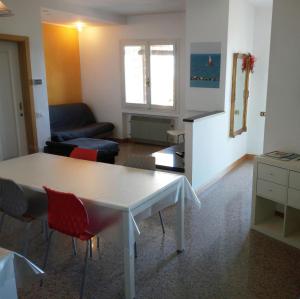 een woonkamer met een witte tafel en stoelen bij My Sea House in Gabicce Mare