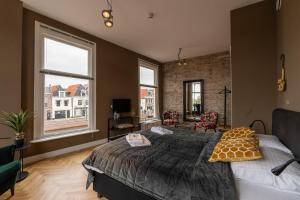 Postel nebo postele na pokoji v ubytování Stadslogement Hoogend