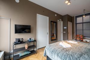 Postel nebo postele na pokoji v ubytování Stadslogement Hoogend