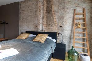 Postel nebo postele na pokoji v ubytování Stadslogement Hoogend