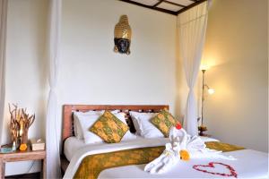 Postel nebo postele na pokoji v ubytování Swar Bali Lodge + 34 fotografií