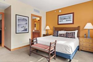 a bedroom with a large bed and a chair at Capitol Peak 3312 in Aspen