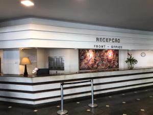 a hotel lobby with a sign that reads repopota front office at Real Residence Hotel in Rio de Janeiro