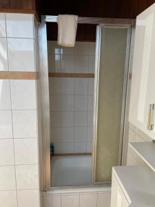 a bathroom with a shower and a bath tub at Hotel Hages in Bad Salzuflen +28 photos