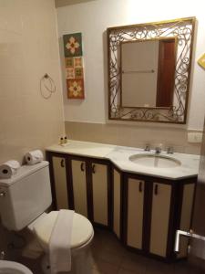 a bathroom with a sink and a toilet and a mirror at Real Residence Hotel in Rio de Janeiro