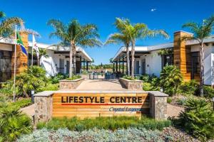 a sign in front of a house with palm trees at Insaka 3 The Blyde Lagoon Experience in Pretoria