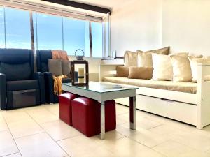 A seating area at Beach Front Apartment-1st Line