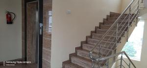a staircase with a metal handrail and a glass door at Madurai Grands Inn in Madurai