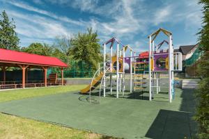 a playground with a slide in a park at Willa Wiesia Rabka Zdrój in Rabka-Zdrój