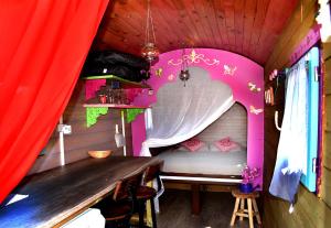 a small room with a bed and a table at Camping Humawaka in Comps-sur-Artuby