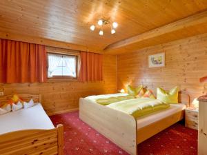 a bedroom with a bed in a wooden cabin at Apartment Comfortappart Eberharter - FGZ305 by Interhome in Bruck am Ziller