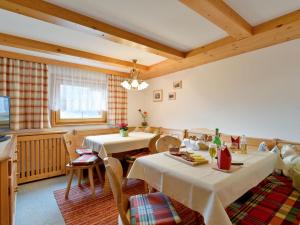 a dining room with two tables and chairs at Apartment Comfortappart Eberharter - FGZ305 by Interhome in Bruck am Ziller