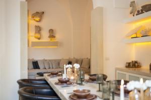 a living room with a table and chairs and a couch at Palazzo Lecce - Epoca Collection in Lecce