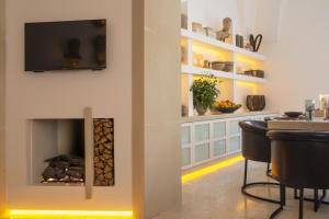 a living room with a fireplace and a bar at Palazzo Lecce - Epoca Collection in Lecce