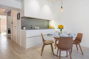 a kitchen and dining room with a table and chairs at ALENKA's PLACE, fiber optic wi fi in Zagreb