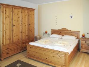 グロヴェにあるApartment Glowe - GLW657 by Interhomeのベッドルーム1室(大型木製ベッド1台、木製キャビネット付)