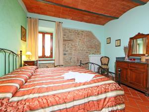 a bedroom with a large bed in a room at Apartment Lucia by Interhome in Podere Panzano