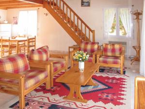 a living room with chairs and a table and stairs at Holiday Home Les Etrilles by Interhome in La Tranche-sur-Mer
