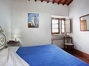 a bedroom with a blue bed in a room at Apartment Pulcino n-3 by Interhome in Starda