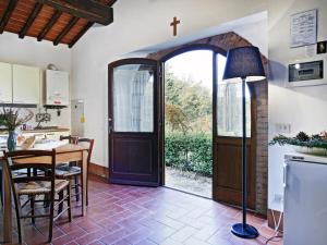 a kitchen with a door and a table with a cross at Apartment Pulcino n-3 by Interhome in Starda