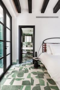 a bedroom with a bed and a green and white floor at Concepcio by Nobis, Palma, a Member of Design Hotels in Palma de Mallorca