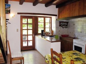 a kitchen with a table and a counter top at Holiday Home Malbosc by Interhome in Saint-Genest-de-Bauzon