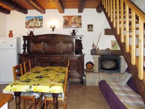 a dining room with a table and a fireplace at Holiday Home Malbosc by Interhome in Saint-Genest-de-Bauzon
