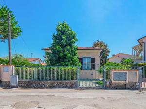 a house with a gate and a tree at Holiday Home Francesca by Interhome in Marina di Pietrasanta