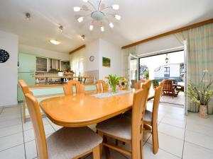 a dining room and kitchen with a wooden table and chairs at Holiday Home Bila Vila by Interhome in Zadar