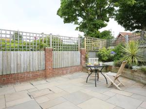 a patio with a table and a fence at Holiday Home Alde End by Interhome in Snape