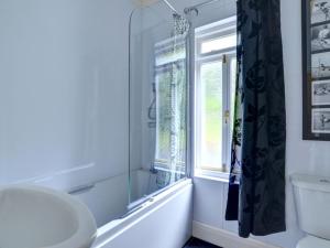 a bathroom with a sink and a window at Holiday Home Arthog by Interhome in Arthog