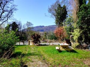 a picnic table in the grass in a field at Holiday Home Arthog by Interhome in Arthog