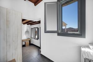 a hallway with a window in a house at Belvedere in Livadi