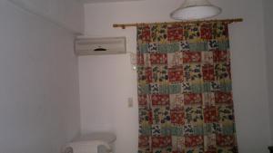 a bathroom with a shower curtain and a toilet at Fania Apartments in Kardamaina