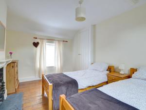 a bedroom with two beds and a window at Holiday Home South Street by Interhome in Dolgellau