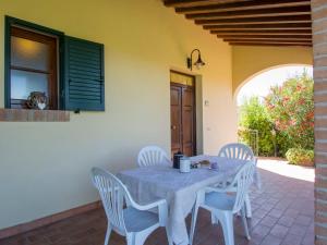 a table and chairs sitting on a patio at Apartment Le Macine-2 by Interhome in Cecina
