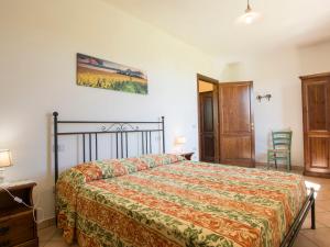 a bedroom with a bed and a table and chairs at Apartment Le Macine-2 by Interhome in Cecina +20 photos