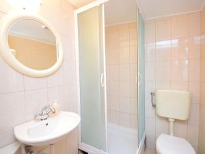 a bathroom with a shower and a sink and a toilet at Apartment Lastavica-2 by Interhome in Jadrija +8 photos