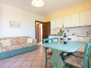 a living room with a table and a couch at Apartment Le Macine-2 by Interhome in Cecina