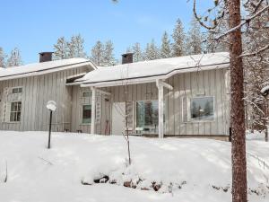 a house with snow on the ground in front of it at Holiday Home Elma-maja by Interhome in Levi